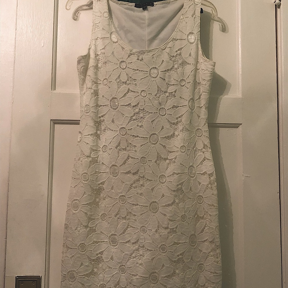 White dress, soft flower design, slightly form fitting, covers to above the knee